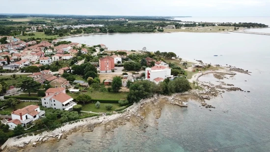 Umag - letecký pohled na pobřeží a město.